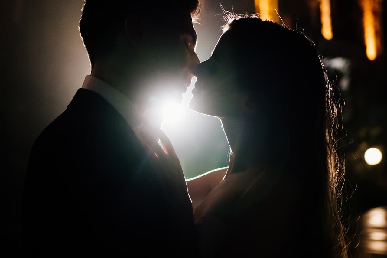 silhouettes of a man and a woman in love in the dark. romance. completion of the wedding celebration.