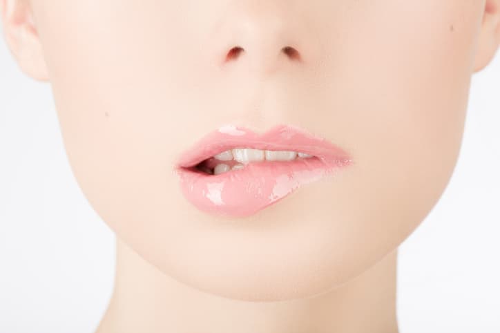 Beauty face closeup. Sexy lips. Beauty pink lips makeup detail. Beautiful make-up close-up. Sensual open mouth. Lipstick and lipgloss