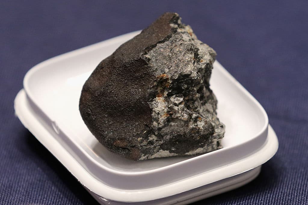 WASHINGTON, DC - JUNE 17: A piece of the Chelyabinsk meteorite is displayed before a hearing of the House Administration Committee in the Longworth House Office Building on Capitol Hill June 17, 2015 in Washington, DC. Famously caught by a number of video cameras, the meteorite fell to earth February 15, 2013 and caused a large amount of damage in the city of Chelyabinsk, Russia. (Photo by Chip Somodevilla/Getty Images)