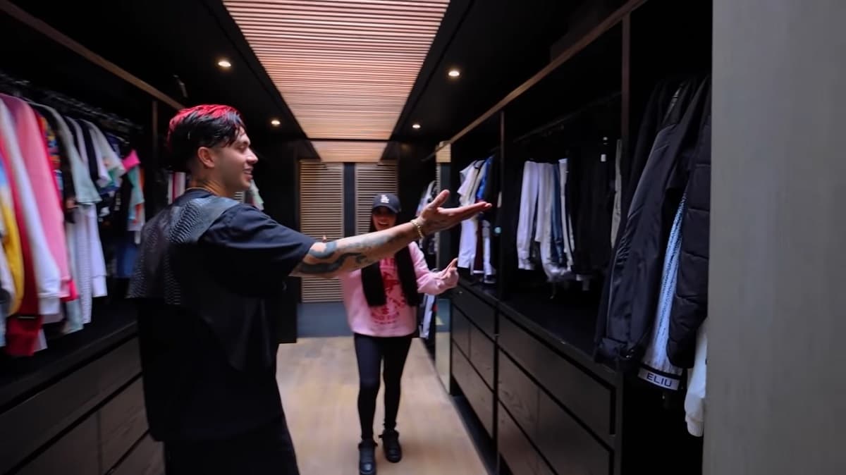 Este clóset tiene anaqueles en color negro, en el que los youtubers tienen toda clase de prendas y además dicha zona da acceso al baño princpial de la habitación principal.
