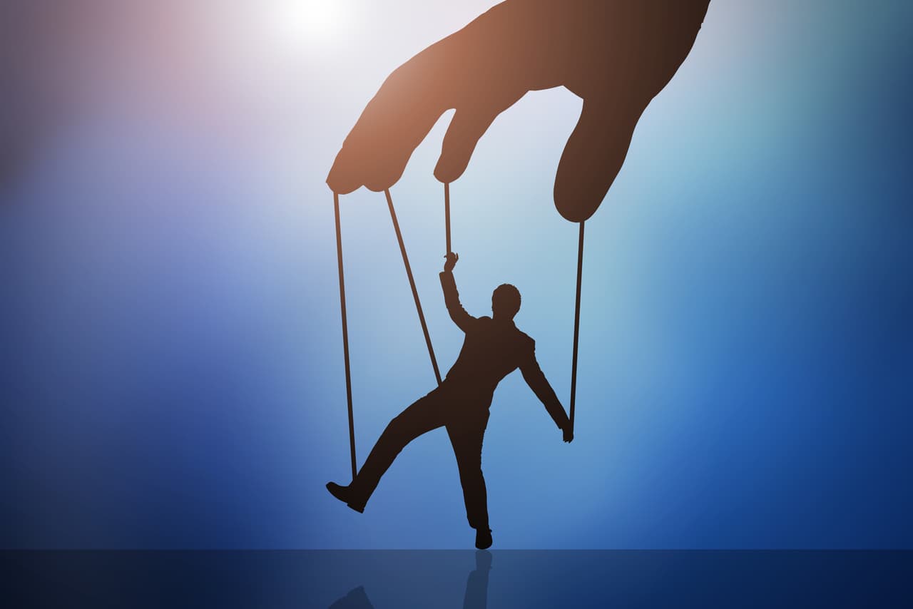 Close-up Of Businessman's Hands Saving Piggybank From Hammering