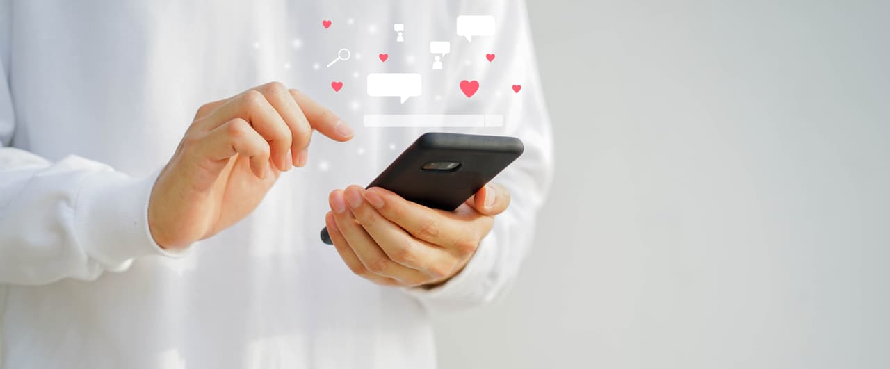 close up young man holding smartphone to using online dating application to talking with other for appointments to flirting for lifestyle people concept
