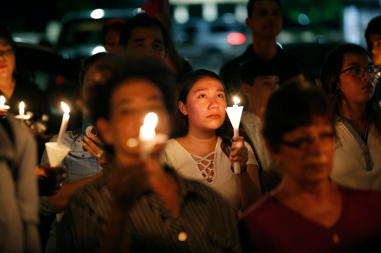 People attend a candlelight vigil for victims of a mass shooting at a shopping complex over the weekend, Monday, Aug. 5, 2019, in El Paso, Texas. (AP Photo/John Locher)
