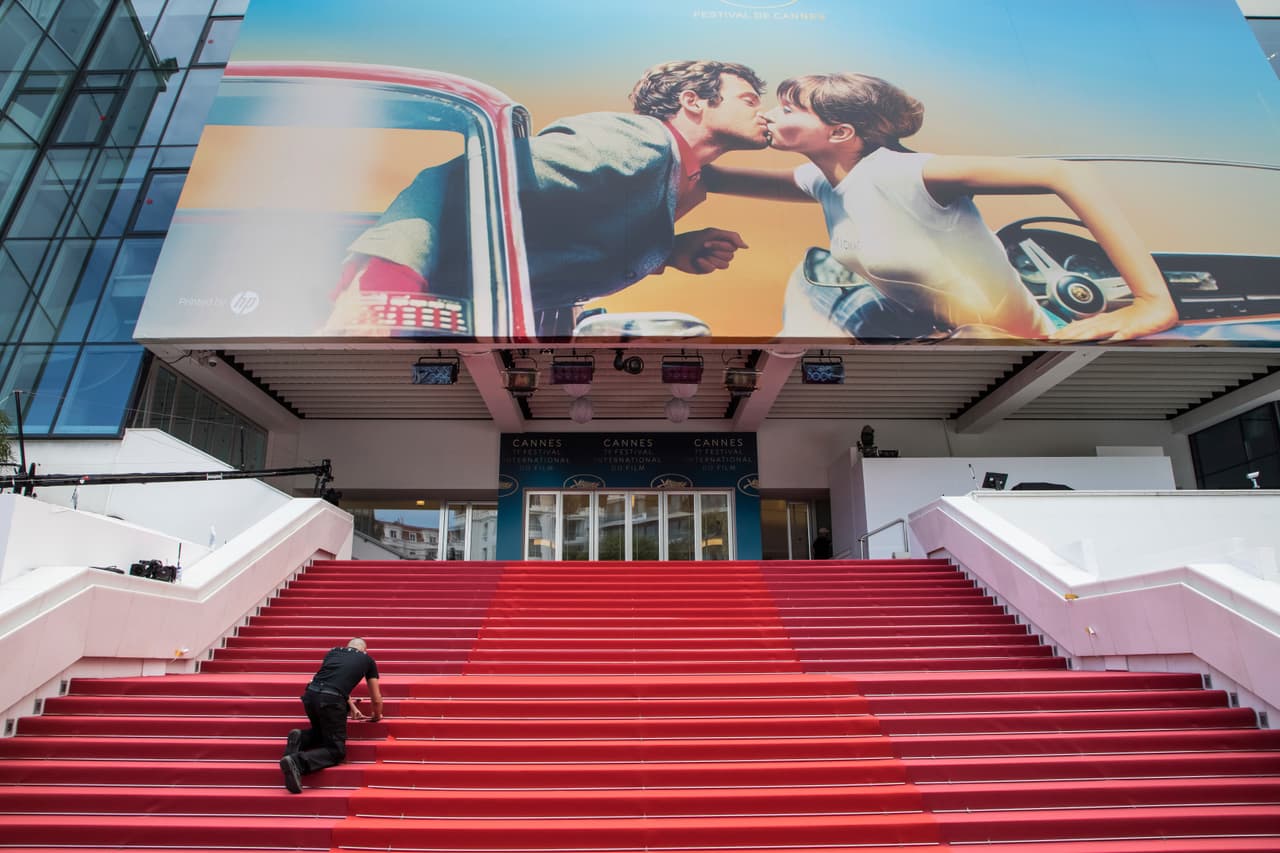 Workers lay down the red carpet on the steps leading to the Palais des Festivals ahead of the 71st international film festival in Cannes, southern France, Tuesday, May 8, 2018. (Photo by Vianney Le Caer/Invision/AP)